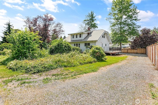 1584 Main St, Lynden, WA 98264 - view of front facade featuring gravel driveway, a chimney, and a wooden deck