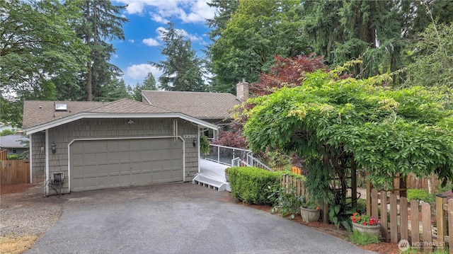 12350 SE 96th Pl, Renton, WA 98056 - view of front of house with driveway, a shingled roof, an attached garage, and a chimney