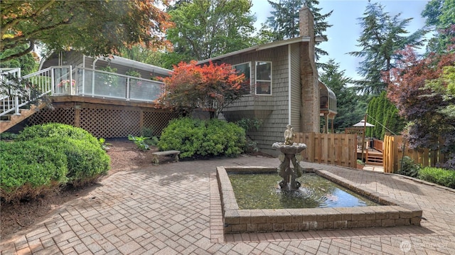 12350 SE 96th Pl, Renton, WA 98056 - view of front facade with stairs, a deck, a garden pond, a chimney, and a patio area