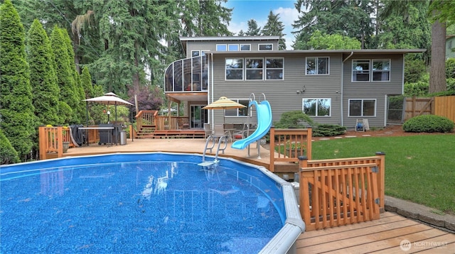 12350 SE 96th Pl, Renton, WA 98056 - swimming pool featuring a wooden deck, a water slide, and a sunroom