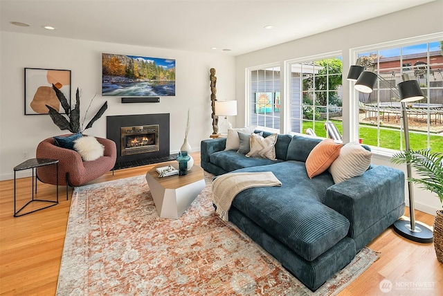 527 16th Ave W, Kirkland, WA 98033 - living room featuring wood finished floors, a warm lit fireplace, and recessed lighting