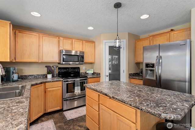 14908 NE 70th St, Vancouver, WA 98682 - kitchen with stainless steel appliances, light brown cabinets, recessed lighting, a kitchen island, and pendant lighting