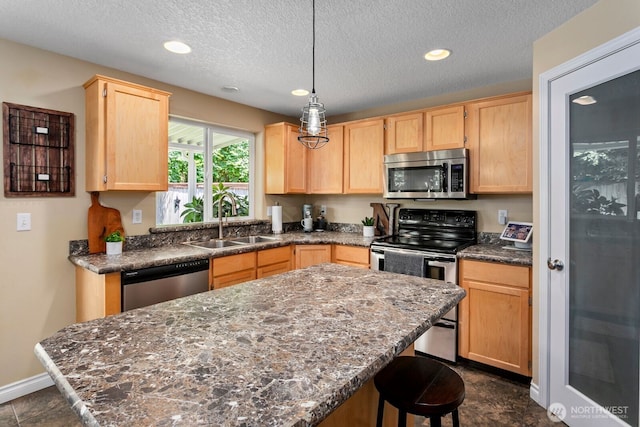 14908 NE 70th St, Vancouver, WA 98682 - kitchen featuring stainless steel appliances, light brown cabinetry, a center island, recessed lighting, and a breakfast bar