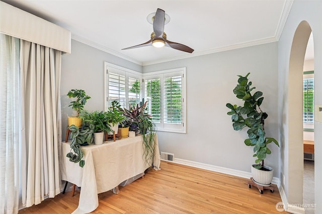806 SW 126th St, Seattle, WA 98146 - living area with arched walkways, plenty of natural light, a ceiling fan, light wood-style floors, and ornamental molding