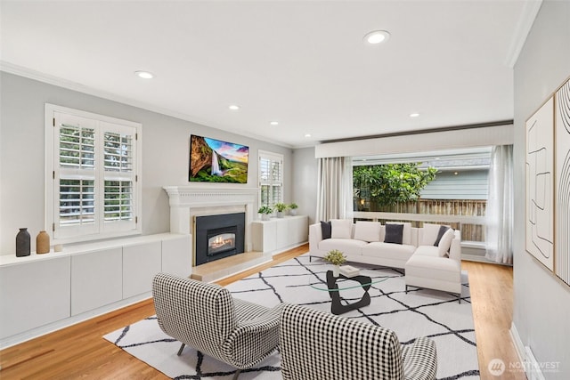 806 SW 126th St, Seattle, WA 98146 - living room with crown molding, light wood finished floors, a lit fireplace, and recessed lighting