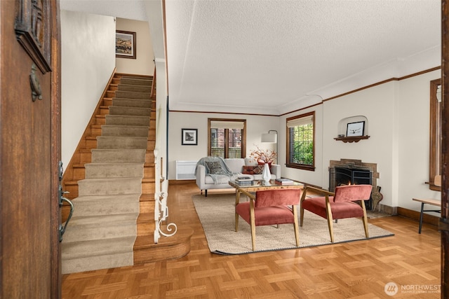 1157 N 78th St, Seattle, WA 98103 - living area featuring stairs, a textured ceiling, crown molding, and a lit fireplace