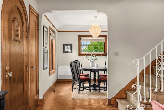 1157 N 78th St, Seattle, WA 98103 - dining space featuring stairway, crown molding, arched walkways, and parquet flooring