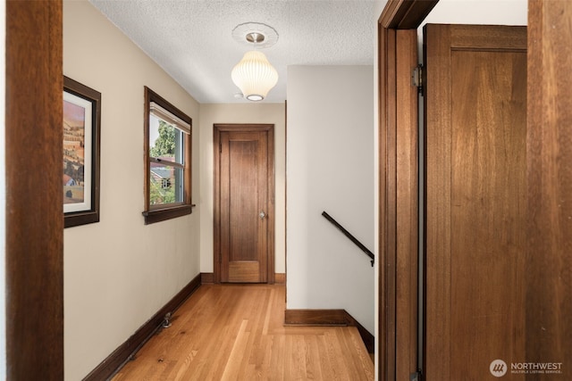 1157 N 78th St, Seattle, WA 98103 - hallway featuring an upstairs landing, light wood finished floors, and a textured ceiling