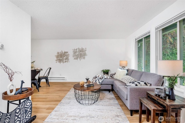 7509 E F St, Tacoma, WA 98404 - living area with light wood-style floors, a textured ceiling, and baseboard heating