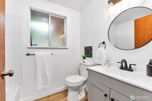 7509 E F St, Tacoma, WA 98404 - bathroom with vanity, wood finished floors, and a bathtub