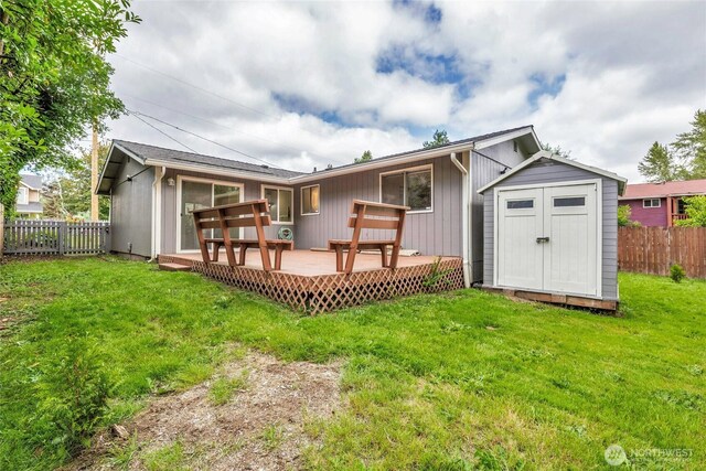 7509 E F St, Tacoma, WA 98404 - back of property featuring a fenced backyard, a storage shed, and a deck
