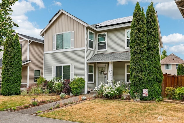 3178 Hoffman Hill Blvd, Dupont, WA 98327 - view of front of property featuring solar panels, board and batten siding, a shingled roof, and covered porch