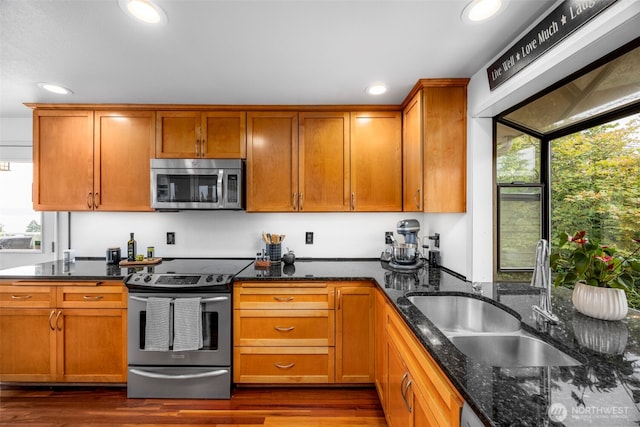8717 182nd Pl SW, Edmonds, WA 98026 - kitchen featuring stainless steel appliances, recessed lighting, dark wood-style floors, dark stone counters, and brown cabinetry