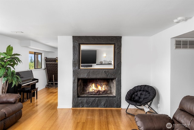 8717 182nd Pl SW, Edmonds, WA 98026 - living room featuring a fireplace, wood finished floors, and a heating unit