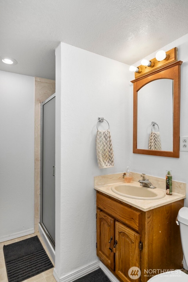 8717 182nd Pl SW, Edmonds, WA 98026 - full bathroom featuring vanity, a shower stall, and a textured ceiling