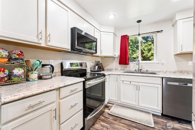 17602 154th Way SE, Yelm, WA 98597 - kitchen with appliances with stainless steel finishes, white cabinets, dark wood-type flooring, pendant lighting, and recessed lighting