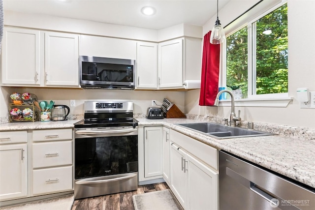 17602 154th Way SE, Yelm, WA 98597 - kitchen with appliances with stainless steel finishes, white cabinetry, light wood-style flooring, light countertops, and recessed lighting