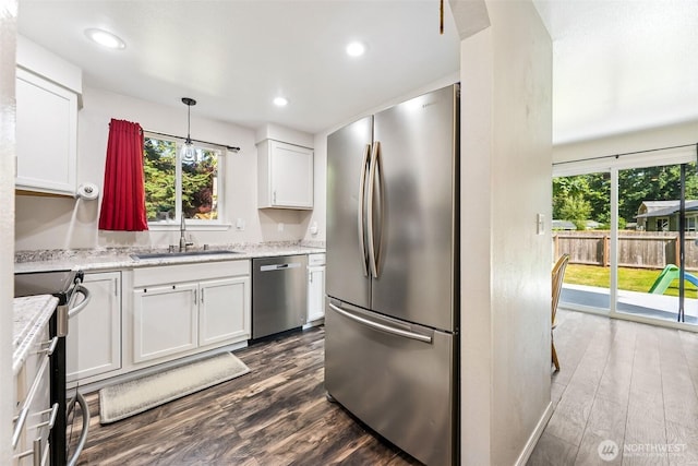 17602 154th Way SE, Yelm, WA 98597 - kitchen featuring appliances with stainless steel finishes, dark wood-style floors, white cabinets, light stone counters, and recessed lighting