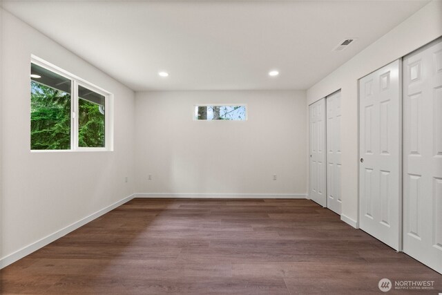 754 SW Oak Rd, Port Orchard, WA 98367 - unfurnished bedroom with multiple closets, multiple windows, recessed lighting, and dark wood finished floors