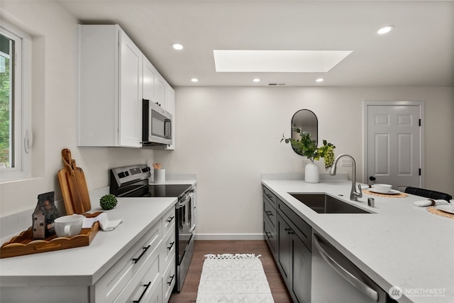 754 SW Oak Rd, Port Orchard, WA 98367 - kitchen featuring appliances with stainless steel finishes, a skylight, light countertops, plenty of natural light, and recessed lighting
