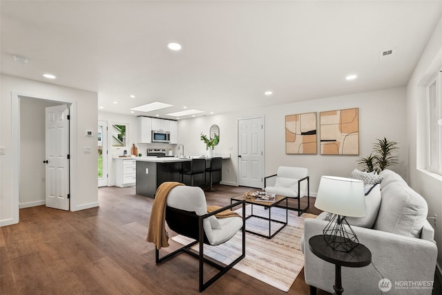 754 SW Oak Rd, Port Orchard, WA 98367 - living room featuring dark wood finished floors, recessed lighting, and a skylight