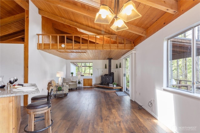 1681 E Saint Andrews Dr N, Shelton, WA 98584 - living area featuring wooden ceiling, a wood stove, a chandelier, and dark wood-type flooring