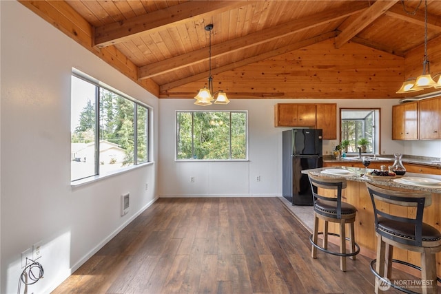 1681 E Saint Andrews Dr N, Shelton, WA 98584 - kitchen with freestanding refrigerator, brown cabinets, wood ceiling, dark wood-type flooring, and a kitchen bar