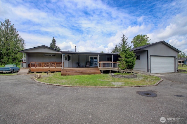 7493 State Route 9, Sedro Woolley, WA 98284 - view of front of home with a garage, asphalt driveway, and a front yard