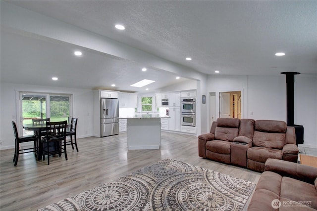 7493 State Route 9, Sedro Woolley, WA 98284 - living area featuring lofted ceiling, light wood-style floors, healthy amount of natural light, recessed lighting, and a wood stove