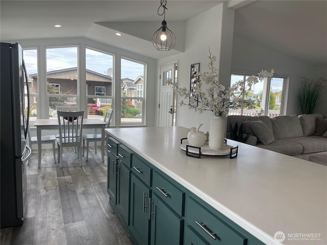 926 N Rock Rose Ave, Sequim, WA 98382 - kitchen with vaulted ceiling, freestanding refrigerator, green cabinetry, plenty of natural light, and wood finished floors