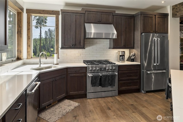 151 Miners Camp Way, Cle Elum, WA 98922 - kitchen featuring premium appliances, extractor fan, dark brown cabinetry, light countertops, and recessed lighting
