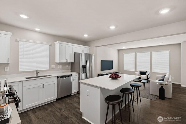 14908 204th Ave E Unit 638, Bonney Lake, WA 98391 - kitchen featuring appliances with stainless steel finishes, open floor plan, a kitchen breakfast bar, dark wood-type flooring, and recessed lighting