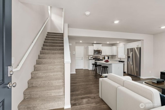 14908 204th Ave E Unit 638, Bonney Lake, WA 98391 - living room featuring dark wood-style floors, stairway, and recessed lighting