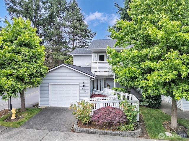 2218 S 336th St Unit 604, Federal Way, WA 98003 - view of front of property with an attached garage, driveway, a balcony, and a shingled roof
