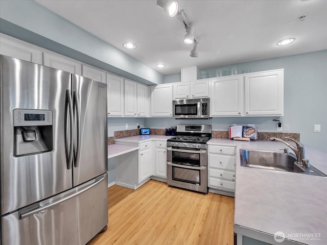 2218 S 336th St Unit 604, Federal Way, WA 98003 - kitchen with stainless steel appliances, light wood-type flooring, white cabinetry, light countertops, and recessed lighting