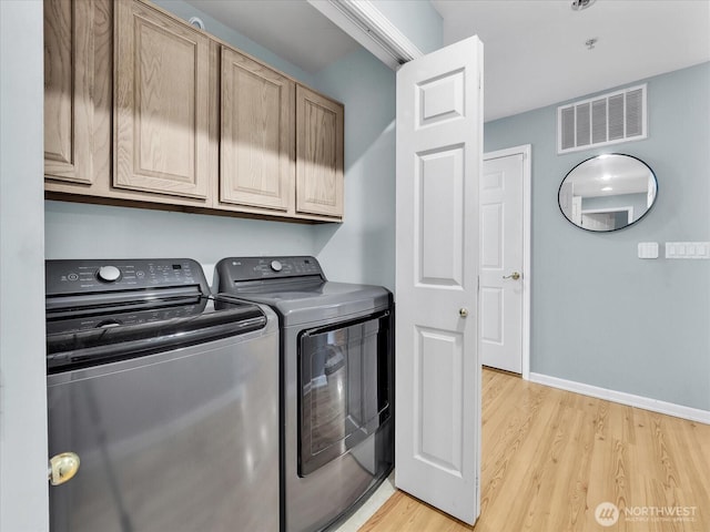 2218 S 336th St Unit 604, Federal Way, WA 98003 - washroom featuring cabinet space, washer and dryer, and light wood-type flooring