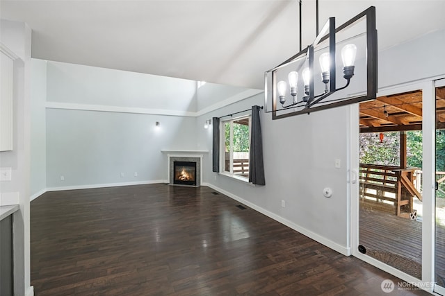 1407 196th St E, Spanaway, WA 98387 - unfurnished living room with dark wood-style floors, a glass covered fireplace, a chandelier, and lofted ceiling