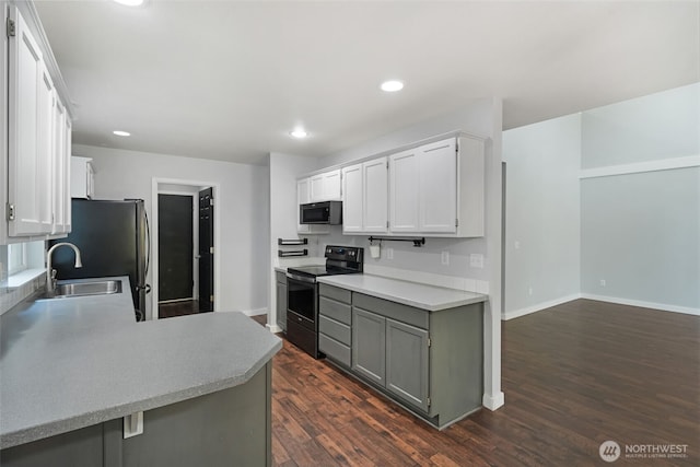 1407 196th St E, Spanaway, WA 98387 - kitchen with electric range, freestanding refrigerator, white cabinets, dark wood-style floors, and light countertops