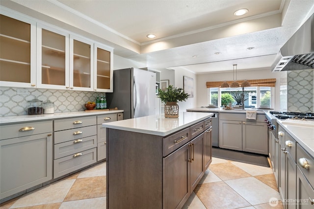1116 N J St, Tacoma, WA 98403 - kitchen featuring wall chimney exhaust hood, appliances with stainless steel finishes, backsplash, gray cabinets, and crown molding