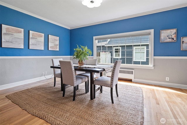 1116 N J St, Tacoma, WA 98403 - dining space with wood finished floors, crown molding, and radiator
