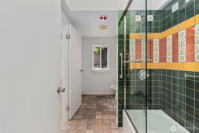 14023 Meridian Ave N, Seattle, WA 98133 - bathroom with bath / shower combo with glass door and stone finish flooring