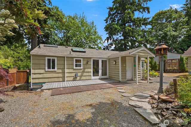 14023 Meridian Ave N, Seattle, WA 98133 - back of property featuring french doors, a wooden deck, and a shingled roof