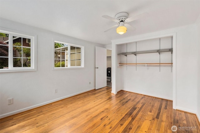 14023 Meridian Ave N, Seattle, WA 98133 - unfurnished bedroom featuring wood finished floors, a closet, and ceiling fan