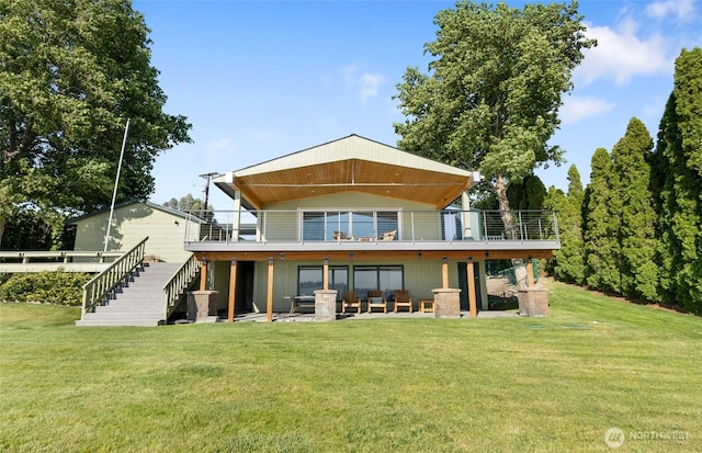 2102 NE Elgin Rd, Moses Lake, WA 98837 - back of property featuring stairs, a lawn, and a wooden deck