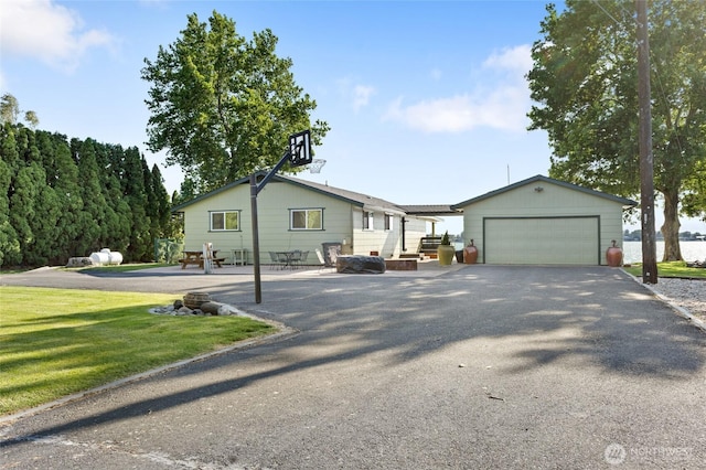 2102 NE Elgin Rd, Moses Lake, WA 98837 - view of front of property with a garage, a front yard, an outdoor structure, and driveway