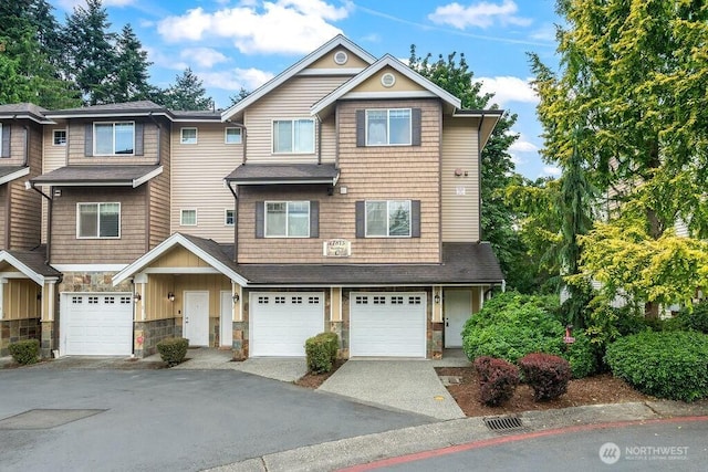 17815 80th Ave NE Unit C-1, Kenmore, WA 98028 - view of property featuring stone siding, driveway, an attached garage, and board and batten siding