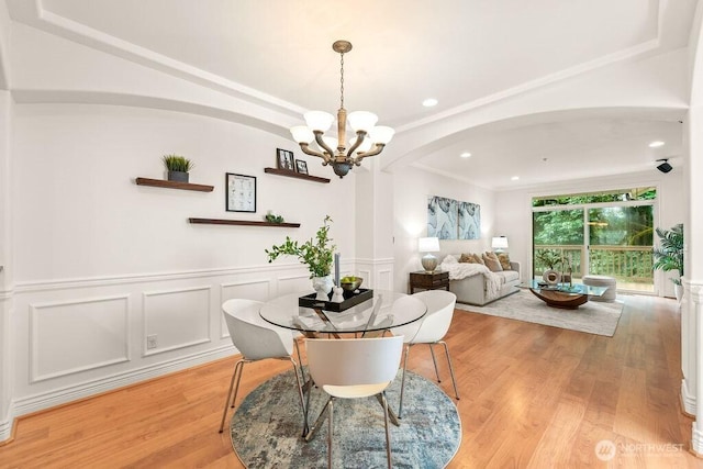 17815 80th Ave NE Unit C-1, Kenmore, WA 98028 - dining space with arched walkways, a chandelier, light wood finished floors, a wainscoted wall, and recessed lighting
