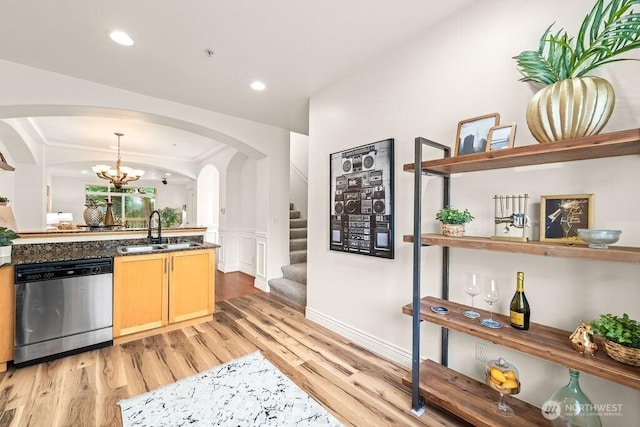 17815 80th Ave NE Unit C-1, Kenmore, WA 98028 - kitchen with stainless steel dishwasher, arched walkways, light wood-style flooring, a chandelier, and a wainscoted wall