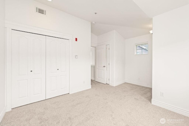 17815 80th Ave NE Unit C-1, Kenmore, WA 98028 - unfurnished bedroom with carpet flooring, vaulted ceiling, and a closet