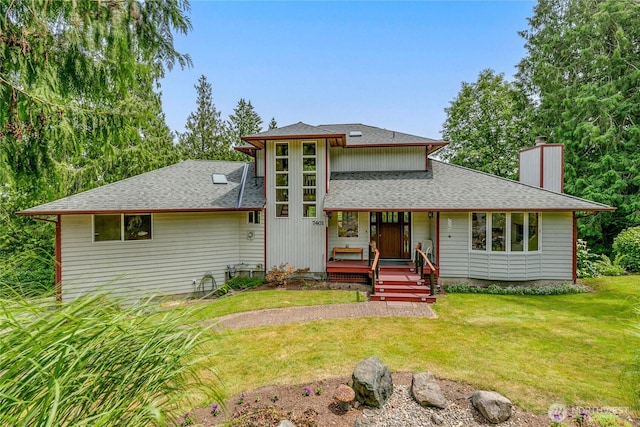 7401 E Heather Way, Everett, WA 98203 - view of front of home with a chimney, a front yard, a shingled roof, and covered porch